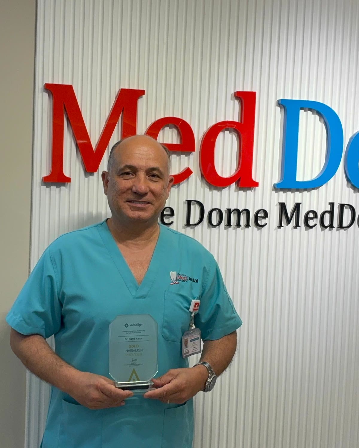 Dr Rami Nahal holding his Gold Invisalign Provider award